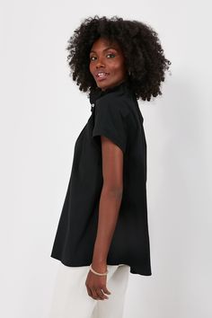 Effortlessly chic, the Rae Blouse takes everything we love about a classic button down and elevates it with fun, feminine details. Featuring a high neck ruffle collar, short cap sleeves, and a button front placket, this classic black shirt pairs well with denim of all colors and gold jewelry for an effortless day to night look from the office to dining out with friends. Ruffle collar Short cap sleeves Front placket Material: 96% Cotton, 4% Spandex Care: Hand wash cold, hang to dry Ruffled Collar Tops With Button Closure For Work, Ruffled Collar Workwear Top With Button Closure, Workwear Tops With Button Closure And Ruffled Collar, Formal Short Sleeve Blouse With Ruffles, Black Feminine Blouse With Ruffled Collar, Chic Peter Pan Collar Tops For Work, Chic Tops With Peter Pan Collar For Work, Daywear Blouse With Peter Pan Collar, Peter Pan Collar Blouse For Work