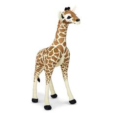 a stuffed giraffe is standing in front of a white background and it's head turned to the side