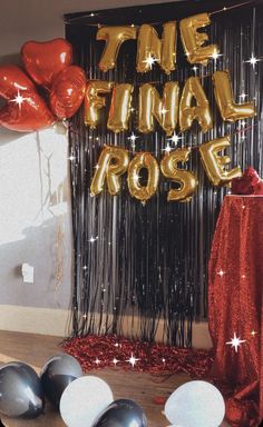 balloons and streamers in front of a backdrop with the words final rose on it