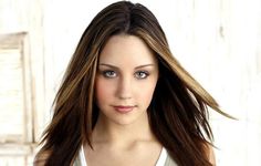 a beautiful young woman with long brown hair