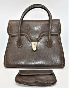 Vintage large Gucci Brown Leather Purse, Hand Bag plus Cosmetics Bag. It has a luxurious amber colored leather interior with numerous compartments: one has a zipper closure, one has a snap and the third hangs freely PLUS there is the large compartment that comprises the majority of the space. As with all Gucci bags, this is made of a very high quality brown leather with impeccable stitching, the classis Gucci logo embossed inside and 4 metal footers to protect the leather on the bottom of the ba Gucci Satchel With Removable Pouch For Everyday, Gucci Top Handle Satchel For Travel, Gucci Satchel With Leather Lining For Travel, Rectangular Gucci Satchel For Evening, Gucci Rectangular Satchel For Evening, Gucci Tote Satchel For Daily Use, Gucci Rectangular Evening Satchel, Vintage Gucci Bag With Leather Lining, Gucci Satchel With Removable Pouch For Formal Occasions