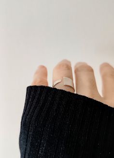 Crafted for elegance and simplicity, this Sleek Sterling Silver Open Band Ring showcases a Contemporary Matte Finish, embodying adjustable minimalism at its finest.  The open band design provides a custom fit for any wearer, while its sterling silver composition ensures lasting shine and durability.  Perfect for those who appreciate modern, understated jewelry, this ring comes in a branded organic cotton pouch, ideal for gifting or as a timeless addition to your collection. To find your size, me Modern Everyday Jewelry With Open Band, Modern Open Band Jewelry For Everyday, Minimalist Adjustable Stackable Rose Gold Rings, Modern Adjustable Rings For Everyday, Sleek Simple Design Ring As Gift, Sleek Simple Design Ring For Gift, Minimalist White Gold Open Band Jewelry, Modern Rose Gold Midi Ring With Open Band, Adjustable Modern Stackable Rings