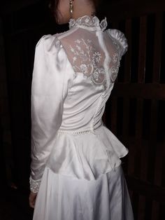 the back of a woman's white wedding dress