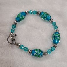 Blue & Green Artisan Glass Beaded Bracelet With Silver Tone Toggle Clasp Glass Beaded Bracelet, Dream Aesthetic, Beaded Crafts, Glass Beaded Bracelets, Toggle Clasp, Beaded Bracelet, Glass Beads, Silver Tone, Jewelry Bracelets