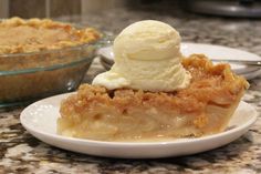 a piece of pie with ice cream on top sits on a plate next to a bowl