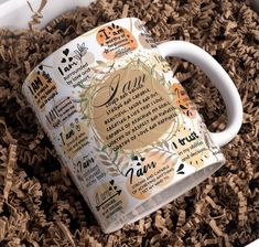 a white coffee mug sitting on top of wood shavings with the words i love you written in it