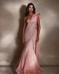 Peach georgette & organza fish sari featuring hand embellished ivory pearls, silver glass bead & tassels on the pallu, with an oversized organza bow detail on the shoulder. Paired with a matching adjustable tie-back one-shoulder blouse.From Shloka Khialani's Winter Sun collection.DELIVERY TIMEPlease allow 6-8 weeks for your outfit to arrive.FABRIC DETAILSGeorgette, OrganzaProfessional cleaning only. Organza Bow, Fancy Sarees Party Wear, Saree Designs Party Wear, Indian Dresses Traditional, Traditional Indian Outfits, Winter Sun, Party Wear Indian Dresses, Indian Wedding Outfits, Silver Glass