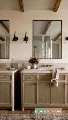 a bathroom with two sinks and mirrors on the wall