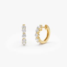 Indulge in sophistication with our 14K Solid Gold Round Diamond Huggie Hoop Earrings. These delicate mini hoops showcase 0.80 carats total weight of authentic round diamonds, imparting a radiant charm to any ensemble. Ideal for birthdays, these elegant diamond hoops seamlessly combine luxury and versatility, becoming a timeless treasure in your jewelry repertoire. Item Details * Gold Kt: 14K Solid Gold * Custom Gold Color:  Yellow Gold, White Gold * Inner Diameter: 10 MM * Outer Diameter: 13 MM * Round Diamonds: 10 pcs 2.7 MM * Diamond CTW: 0.80 ctw (pair) * Diamond Color-Clarity: G Color SI Clarity * Ready to Ship in 1-2 Business Days ▶ See more of our Diamond Earrings - http://etsy.me/2lyqVBP ▶ See our storefront here - http://etsy.me/2lUcVnH  ▶ All store sections here * Diamond Rings - Diamond Huggies, Gold Armband, Ruby Jewelry, Emerald Jewelry, Sapphire Jewelry, Huggie Hoop Earrings, Gold Wedding Band, Jewelry Earrings Hoops, Gold Bangles