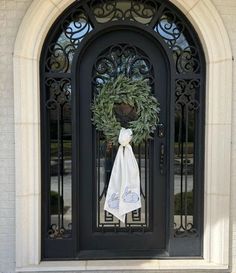 a black door with a wreath on it