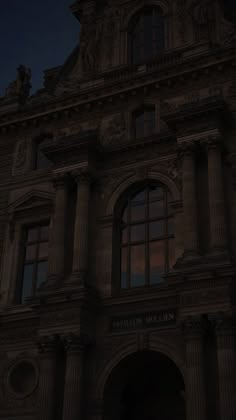 an old building with many windows at night