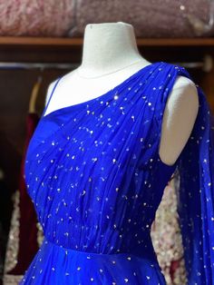 This sparkle blue milky way one-shoulder gown with heavy embellishments with sequin and swaroski work is a contemporary pick with golden sequence border design. Make an grand entry on your special day in this beautiful gown. Fabric: Net Size: 38/M Ready to Ship! Royal Floor-length Party Gown, Royal Blue Sequin Gown For Wedding, Blue Sequined Wedding Gown, Glamorous Blue Evening Lehenga, Glamorous Blue Lehenga For Evening, Royal Blue Glamorous Wedding Gown, Glamorous Floor-length One Shoulder Dress For Wedding, Glamorous Royal Blue Wedding Gown, Glamorous Floor-length One Shoulder Wedding Dress