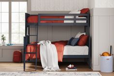 a bunk bed with red and white pillows