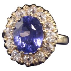 Beautiful Retro 14K Yellow Gold Ceylon Sapphire and Diamond Engagement Ring. This classic ring features a 5.12 ct No Heat color changing ceylon sapphire in the center of a halo of old european cut diamonds. This ring also comes with an AGL report stating the sapphire is natural and has no treatments done to it. Item #R0932 Metal: 14K Yellow Gold Weight: 6.3 Grams Diamond: Approximately 1.50 cts Color: H Clarity: VS2 Sapphire: 5.12 cts Ceylon No Heat / Color Change - AGL - # 1105492 Ring Size: 5 Measurements: Top measures 17.39 mm wide and band measures 2.42 mm wide. Measurement from finger to top of ring: 7.43 mm Layaway: For your convenience, we will be happy to provide layaway payment options. Please contact us to work out a layaway plan which best suits your needs. All layaway purchases Ceylon Sapphire Ring, Sapphire And Diamond Engagement Ring, Diamond Sapphire Engagement Ring, Ceylon Sapphire, Cushion Cut Diamonds, No Heat, European Cut Diamonds, Art Deco Diamond, 14k White Gold Ring