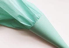 a green umbrella laying on top of a white table