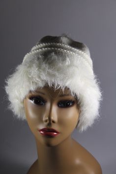 "This hand knit hat is knit with two yarns. A faux fur in white and a blended yarn of 65% wool and 35% alpaca in white. It is of medium weight, approximately 8 1/2\" in length. This fun looking knit hat with white faux fur trim is fun and sassy! Wear it with style for the winter! CARE INSTRUCTIONS Dry Clean Only" Warm White Wool Hat, White Fur Felt Hat For Winter, White Fur Felt Winter Hat, White Knit Beanie Bonnet, Elegant Knitted Hats For Winter, White Winter Hat, One Size Fits All, White Wool Hat With Short Brim, White Winter Hat One Size Fits All, White Winter Hat One Size