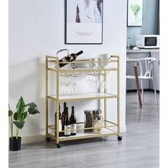 a gold bar cart with wine glasses on it