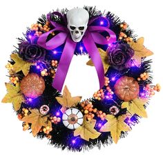 a wreath decorated with purple and orange decorations, including a skull on the front door