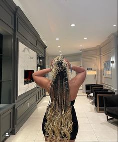 a woman with long hair standing in a room