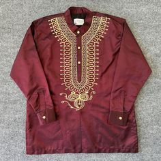 Introducing the Zorora Long Sleeve Shirt by Simenzz Designs. This stylish T-Shirt features intricate embroidery accents that add a touch of African flair to any outfit. It comes in a variety of sizes, from S to XXXL, and is perfect for men who want to make a statement. The shirt is made in the United States and is available in a rich burgundy color. The long sleeve design is perfect for cooler weather, making it a versatile addition to any wardrobe. Choose the Zorora Long Sleeve Shirt for a unique, eye-catching piece that is sure to turn heads. Pants are sold separately. Purchase both shirt and pants for a discounted price.  Message us for deal! Traditional Short Sleeve Tops For Eid, Traditional Crew Neck Top For Festivals, Traditional Long Sleeve Shirt With Intricate Embroidery, Festive Long Sleeve Tops With Intricate Embroidery, Traditional Long Sleeve Tops With Tonal Embroidery, Festive Traditional Tops With Tonal Embroidery, Traditional Festive Shirt With Floral Embroidery, Festive Traditional Shirt With Floral Embroidery, Festive Long Sleeve Shirt With Floral Embroidery