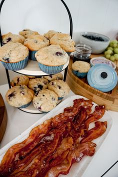 some muffins and bacon are sitting on a table