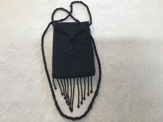 Period: before 1980's Provenance: France Execution: artisan  hand made Materials: small black beads , satin, synthetic fibre  Recycling material: yes Dimensions:  - inner deep.                       13.5 cm - 5.31" - total height                          15 cm - 5.90" - width.                                  9.5 cm - 3.74" - total cord length.               92 cm -  36.22" - total height end to end     66 cm -  25.98" Condition: don't missing beads, very good vintage condition. Delivery in good Evening Black Beaded Necklaces, Vintage Black Handmade Beaded Necklaces, Vintage Black Beaded Necklace For Party, Adjustable Black Vintage Beaded Necklace, Adjustable Black Beaded Necklaces For Evening, Adjustable Black Beaded Necklace For Evening, Vintage Black Beaded Necklace For Gift, Black Handmade Beaded Necklaces For Evening, Purse Gift