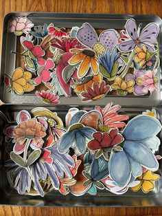 two metal trays filled with different colored flowers