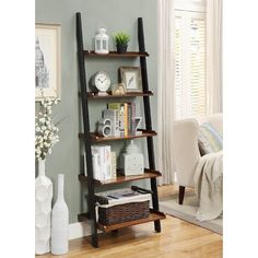 a leaning shelf with books, magazines and other things on it in a living room