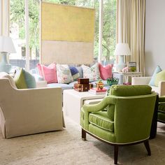 a living room filled with furniture and lots of windows