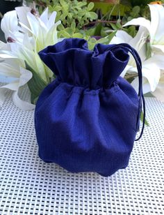 a blue bag sitting on top of a table next to flowers