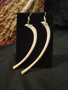 the earrings are made out of wood and have curved ends