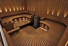 the inside of a wooden sauna with benches and lights on it's sides