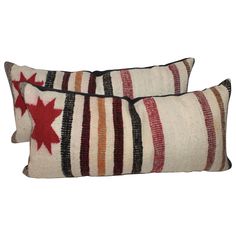 two striped pillows with red stars on them