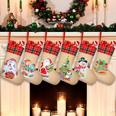 christmas stockings hanging from a mantel with candles