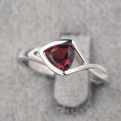 Ring details metal: silver/14k white(rose/yellow) gold center stone: trillion shape 6*6mm (0.93ct) garnet accent stone: cz NOTE: if it is silver or white gold, it will be get plated with rhodium Customization is available you can change, add or remove any parts of the ring if you have good idea. I can add special engraving inside the shank of the ring by free (words, date, simply simbles and so on) too. I am happy to help out or make any adjustments to your order if you have a special request. P Trillion Cut Birthstone Ring For Promise, Trillion Cut Birthstone Promise Ring, Trillion Cut Sterling Silver Ring With Gemstone, Trillion Cut Gemstone Birthstone Ring For Anniversary, Trillion Cut Birthstone Ring For Anniversary, Elegant Triangle Rings For Anniversary, Elegant Trillion Cut Birthstone Rings, Silver Trillion-cut Birthstone Ring, Silver Trillion Cut Gemstone Ring