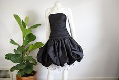 "Description: A strapless black party dress with a bubble hem skirt and little sheer polka dot underlayer. Back nylon zipper, boning in the bodice.  Measurements of garment, allow space for fit.  Bust: 31\" Waist: 25\" Hips: 40\" Length: 32\" Shoulder to hem: Sleeve Length from shoulder: I take my measurements flat, and double for circumference.  Tag: No brand Fabric: Synthetic, unsure exact content. Condition: Excellent Follow along on instagram @lovecharlesvintage" Fitted Bubble Hem Party Dress, Fitted Bubble Hem Dress For Party, Fitted Bubble Hem Evening Dress, Elegant Bubble Hem Party Dress, Elegant Party Bubble Dress With Bubble Hem, Strapless Bubble Dress For Spring Party, Ruffled Bubble Dress For Party, Strapless Polka Dot Party Dress, Party Bubble Dress With Ruffles