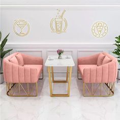 two pink chairs sitting next to each other in front of a table with drinks on it