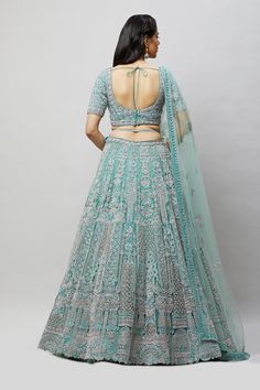 A beautiful sea green lehenga with tonal and silver stonework! Fabric: Net with satin lining All preorders will be handled by a Nazranaa Bridal Consultant who will virtually discuss measurements and minor changes according to the client's specifications Occasion: Wedding Reception WASH CARE INSTRUCTIONS - Please Dry clean only when it is applicable. Slight color variation is possible due to digital photography. Jewelry not included Designer Silver Lehenga With Cutdana, Designer Turquoise Embroidered Lehenga, Designer Embroidered Turquoise Lehenga, Bollywood Style Turquoise Sharara For Wedding, Bollywood Turquoise Sharara For Wedding, Turquoise Bollywood Sets For Reception, Bollywood Style Turquoise Sets For Reception, Bollywood Turquoise Sets For Reception, Turquoise Anarkali Choli For Wedding