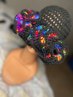 a close up of a knitted hat on a mannequin head