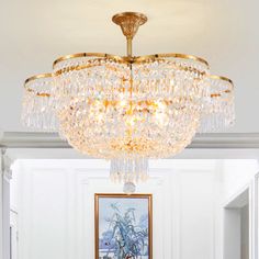 a chandelier hanging from the ceiling in a room with white walls and flooring