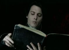 a man reading a book in the dark