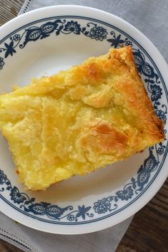 a piece of quiche on a blue and white plate