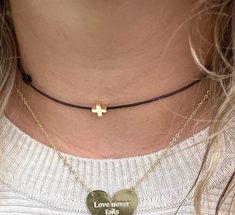 This dainty and minimalist choker necklace features a dainty tiny gold cross charm that adds a touch of spirituality to your outfit.  This choker is delicate and comfortable to wear.  You will look adorable wearing this tiny necklace. The cute necklace you'll never want to take off. This cross choker makes a meaningful gift for a loved one or a cherished addition to your own jewelry collection.  Perfect as a layering necklace. ♥ ITEM DETAILS: Total length: The size of the necklace is ADJUSTABLE.  Materials: Waxed Cord Necklace. Gold Plated Tiny Cross.  Waxed Cord Available: Black - Dark Brown - Light Brown - Turquoise - Peach - Baby Blue -  Hot Pink - Beige - Khaki - Baby Pink - Green - Orange - Yellow - Lilac - Red. Waxed Cord Size: 1mm waxed cord.  ♥ GIFT IT Jewelry comes in a cute bag r Delicate Adjustable Everyday Choker, Minimalist Choker Jewelry With Adjustable Length, Minimalist Adjustable Choker Jewelry, Minimalist Adjustable Choker, Simple Adjustable Choker As Gift, Simple Choker As Gift, Adjustable Gold Choker With Cord, Adjustable Gold Choker, Gold Choker With Adjustable Cord