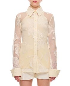 This Sportmax lace shirt features a pointed collar and intricate see-through floral patterns, making it suitable for both elegant and casual occasions. The refined buttoned closure and cuffs add to its feminine charm.

- Pointed collar  
- See-through floral patterns  
- Buttoned closure  
- Cuffs White Shirt With Hidden Button Closure For Spring, Luxury Spring Shirt With Button Closure, Luxury White Collared Blouse, Fitted White Blouse With Lapel Collar, Luxury Buttoned Shirt For Spring, White Fitted Blouse With Lapel Collar, Designer Lapel Collar Top For Spring, Cream Formal Shirt With Spread Collar, Formal Cream Spread Collar Shirt