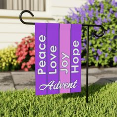 a purple flag with the words peace love hope and adventure on it in front of some flowers