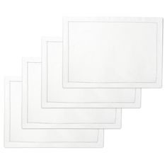 four white placemats with stitching on the edges, each in different sizes