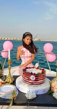 a woman cutting a cake on top of a boat