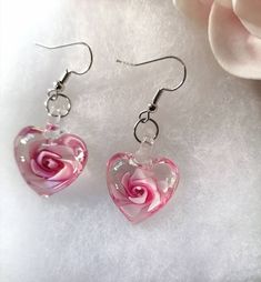 Murano Glass Pastel Pink handmade flower heart earrings, subtly attracting and reflecting surrounding colours. Polished silver used for hook. Lightweight to wear.  A special Gift for her, self treat, Valentines gift, Wedding anniversary gift for her, Bridesmaids' gifts, Mothers day or birthday gift.. Total height / drop of earring - Approx 3.8cm Height of glass heart -Approx 1.8cm  Width of glass heart - Approx 1.8cm  Available in purple/mauve. Please see separate listings. All earrings are handcrafted with passion and care, making each earring unique. Materials are carefully selected and crafted and more styles are available in my shop. Earrings are presented in a display card and can be gift wrapped if you wish. Please select your choice at the menu.  Please don't hesitate to contact me White Flower Earrings For Valentine's Day, Cute Flower Jewelry For Valentine's Day, Silver Flower Earrings For Valentine's Day, Pink Round Earrings For Valentine's Day, Pink Heart Charm Earrings For Mother's Day, Heart-shaped Earrings For Mother's Day, Mother's Day Pink Heart Charm Earrings, Pink Flower-shaped Earrings For Valentine's Day, Pink Heart Earrings For Wedding And Mother's Day