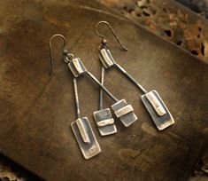 'Squared' earrings are hand sculpted of sterling silver. I like a bold pair of earrings that are easy to wear, and that is just what these are. Minimalist architectural lines with a simple nod to unique design, 'Squared' are a bit of modern with a side of grit. To see the rest of my shop: http://taylorseclectic.etsy.com Length of Earrings (top to bottom including earring hook): 2 3/4 inches Width of Earrings (side to side): 1 1/2 inch Medium: sterling silver Contemporary Earrings With Oxidized Finish, Contemporary Earrings With Oxidized Finish As Gift, Modern Silver Earrings With Rectangular Pendant, Contemporary Oxidized Finish Earrings For Gift, Contemporary Oxidized Finish Earrings, Modern Silver Rectangular Pendant Earrings, Modern Oblong Sterling Silver Earrings, Modern Sterling Silver Oblong Earrings, Artistic Hand Forged Sterling Silver Earrings