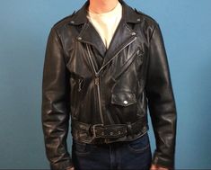 "Vintage 90's black leather motorcycle jacket Snap down collar, lapels and shoulder epaulets Traditional zippered sleeve cuffs Attached half belt with heavyweight nickel plated square buckle Three outside zippered pockets plus small functional coin flap pocket Two interior pocket Fixed nylon insulated lining Jacket exterior is in excellent condition with minimal wear Jacket interior is in great condition Labels are intact Name on label - Open Road Size on label - 42 Approximate Measurements: Sho Winter Biker Jacket With Belt Loops, Winter Moto Biker Jacket With Belt Loops, Moto Biker Jacket With Belt Loops For Winter, Biker Jacket With Belt Loops For Biker Events, Biker Jacket With Belt Loops, Long Sleeve Biker Jacket With Belt Loops, Leather Motorcycle Outerwear With Zipper Closure, Black Leather Motorcycle Jacket With Zipper Closure, Vintage Black Leather Jacket With Button Closure